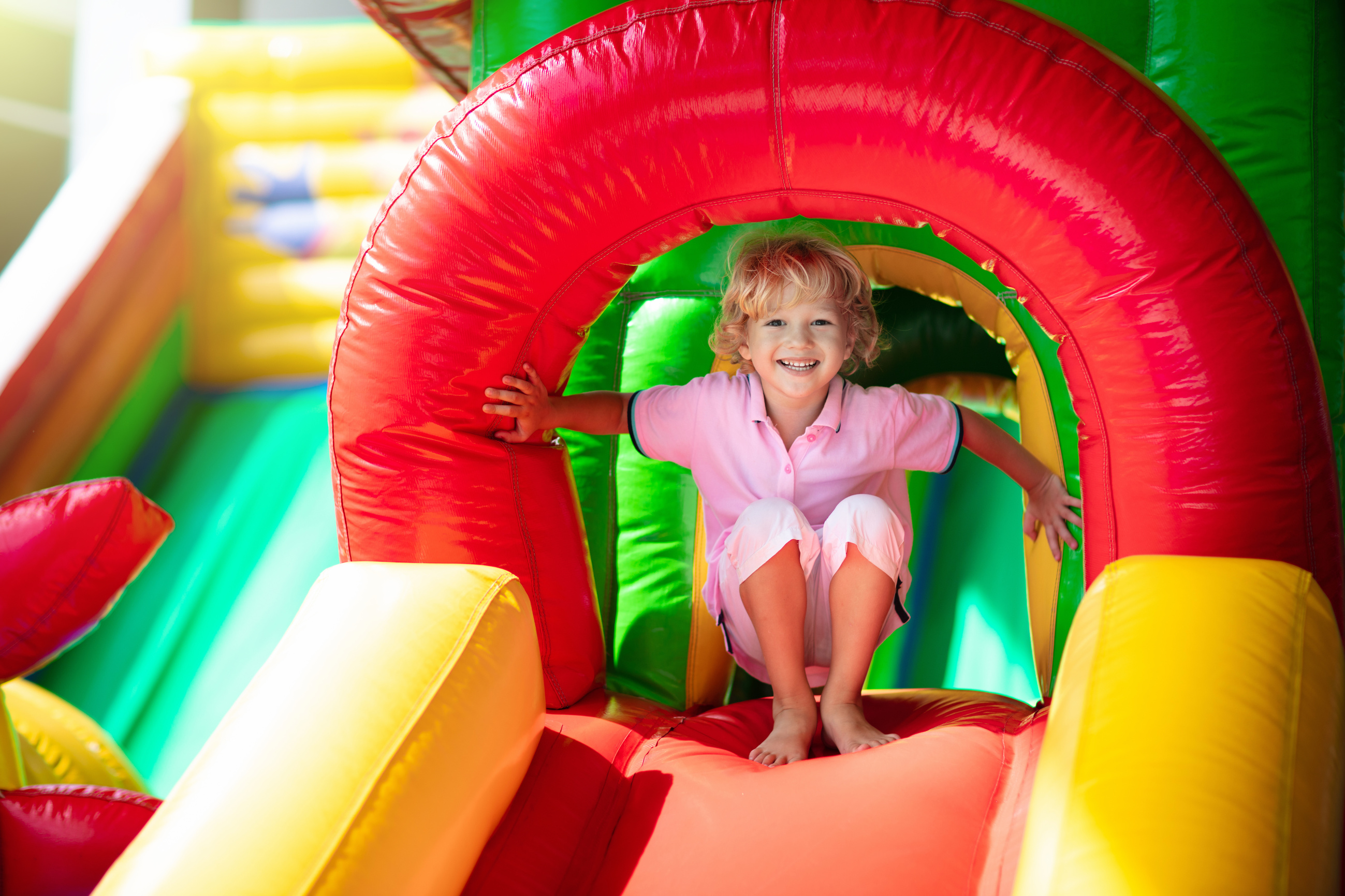 Child jumping on playground trampoline. Kids jump.